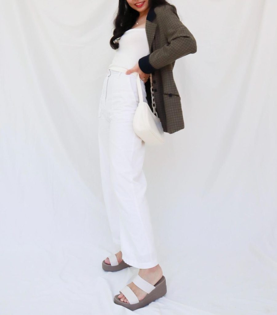 model in white and army green outfit, minimalistic fashion, thrifted from vintage stores